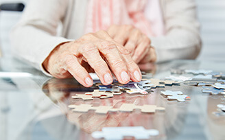 Older patient playing with puzzle
