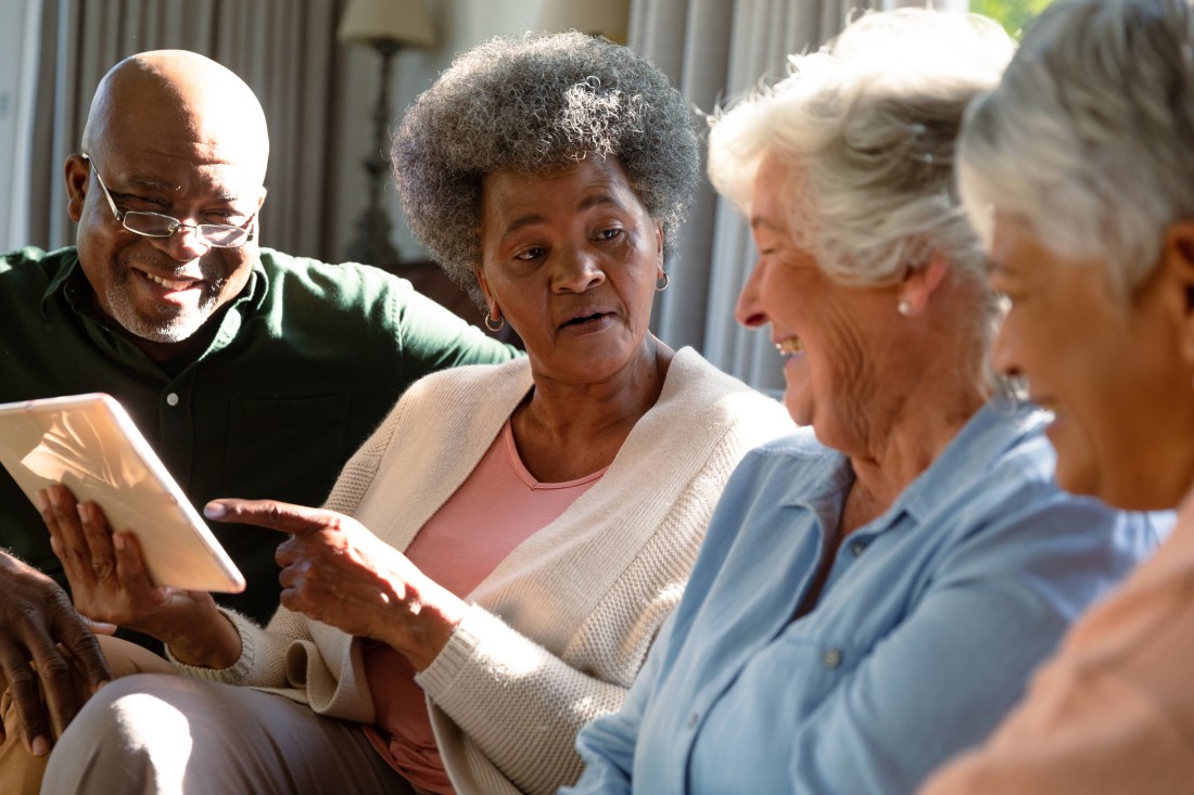 Caregiver and senior holding hands